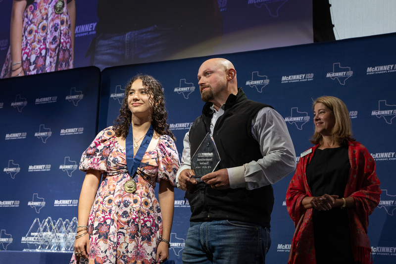 on stage with award