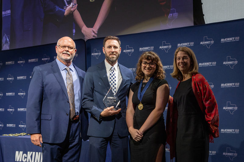 on stage with award
