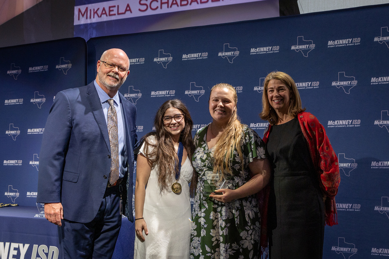on stage with award