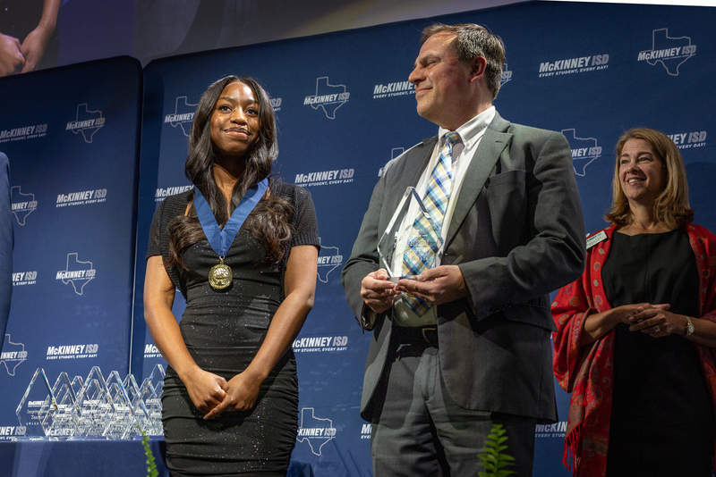 on stage with award