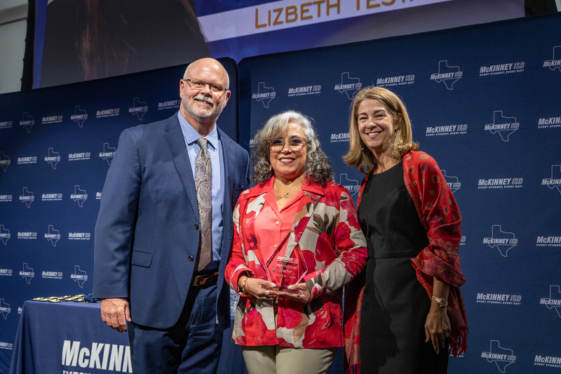 on stage with award