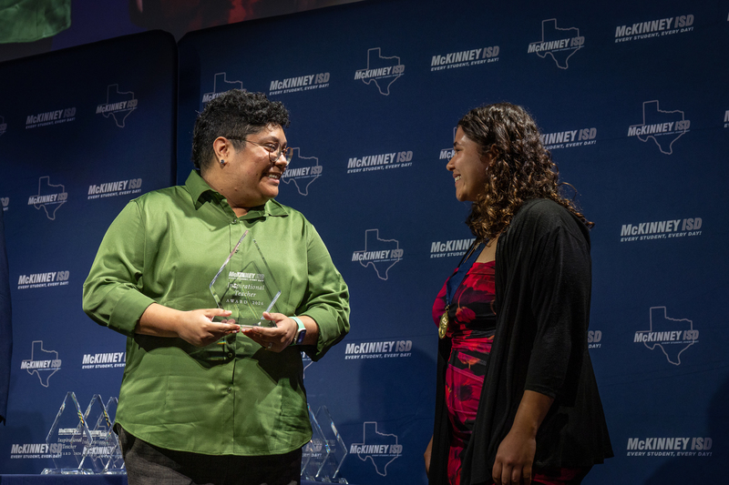 on stage with award
