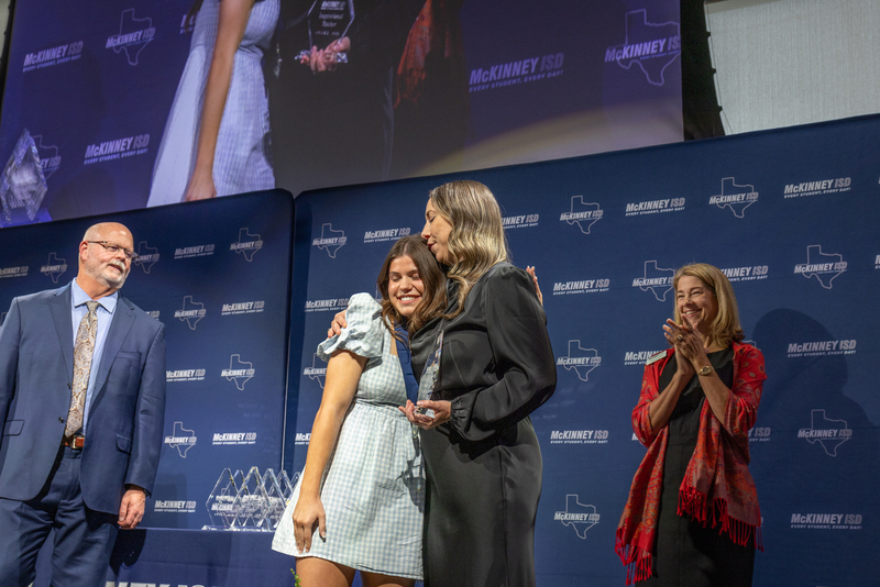 on stage with award