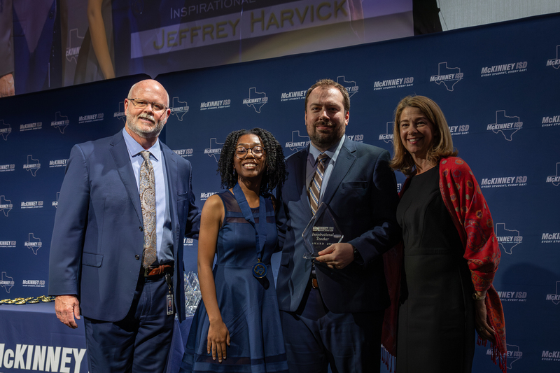 on stage with award