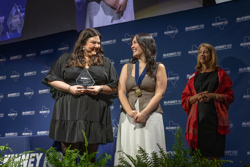 on stage with award