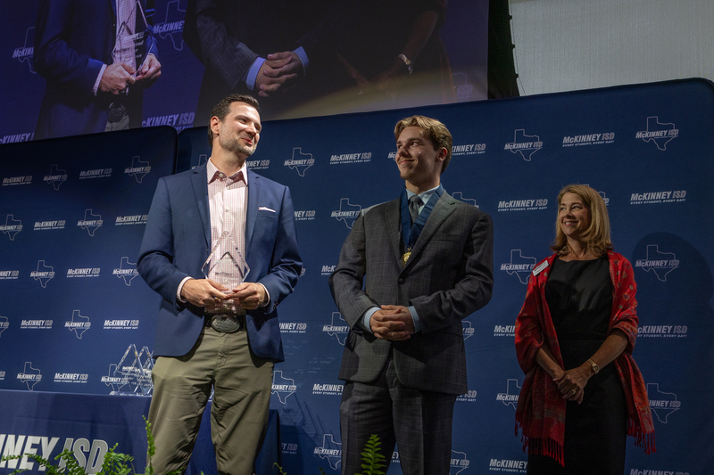 on stage with award