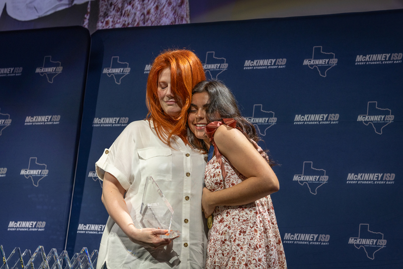 on stage with award