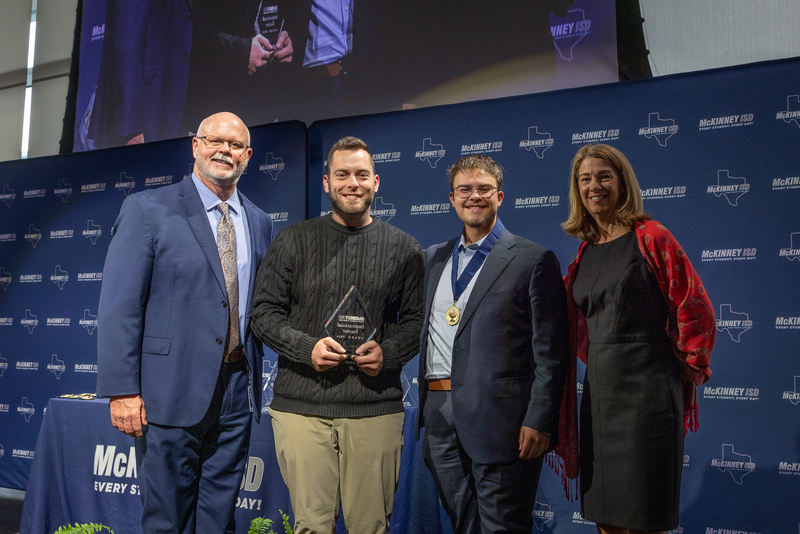 on stage with award