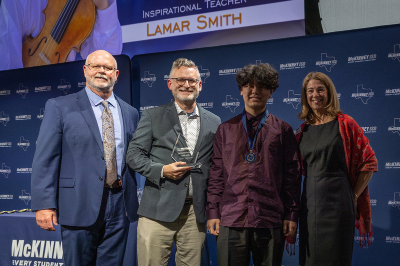 on stage with award