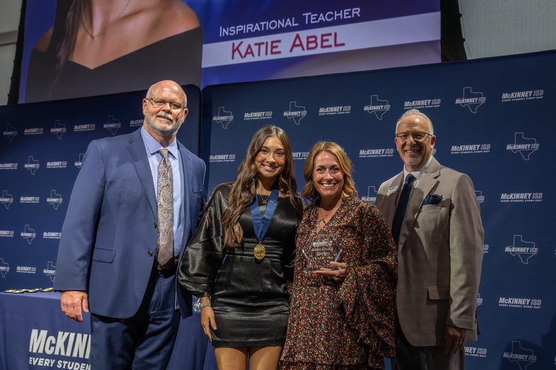 on stage with award