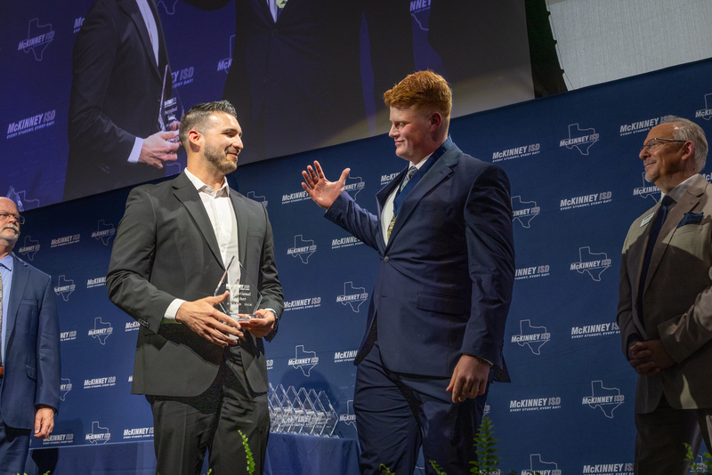 on stage with award