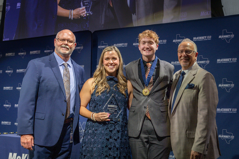 on stage with award
