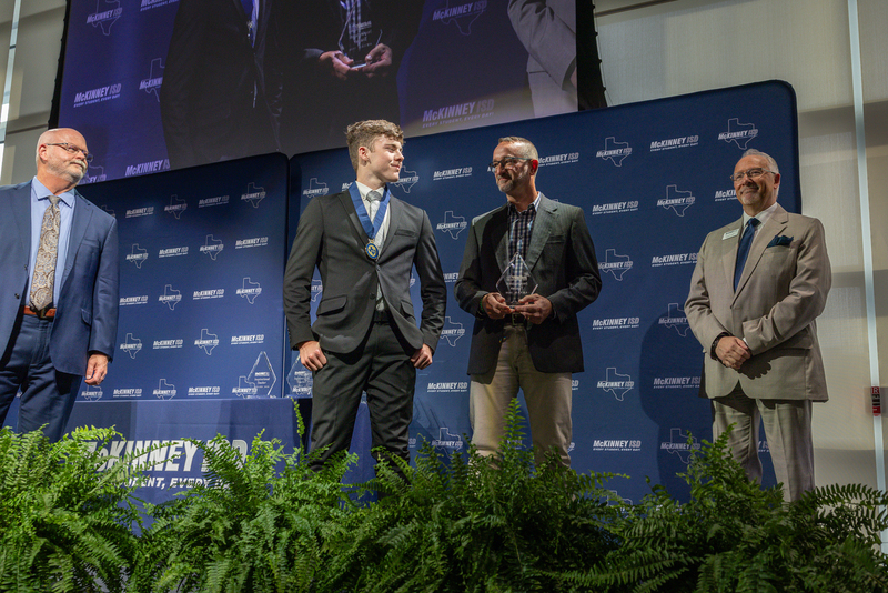 on stage with award
