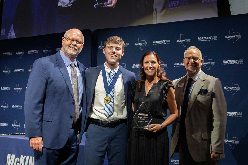on stage with award