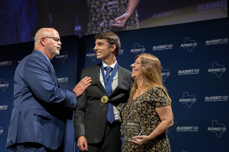 on stage with award