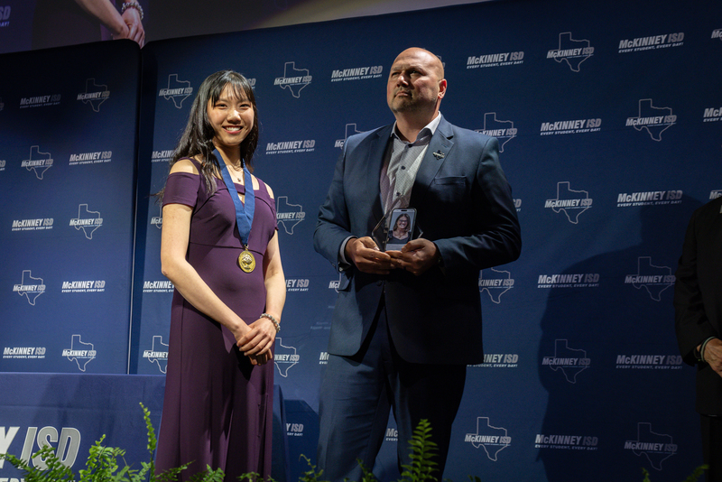 on stage with award
