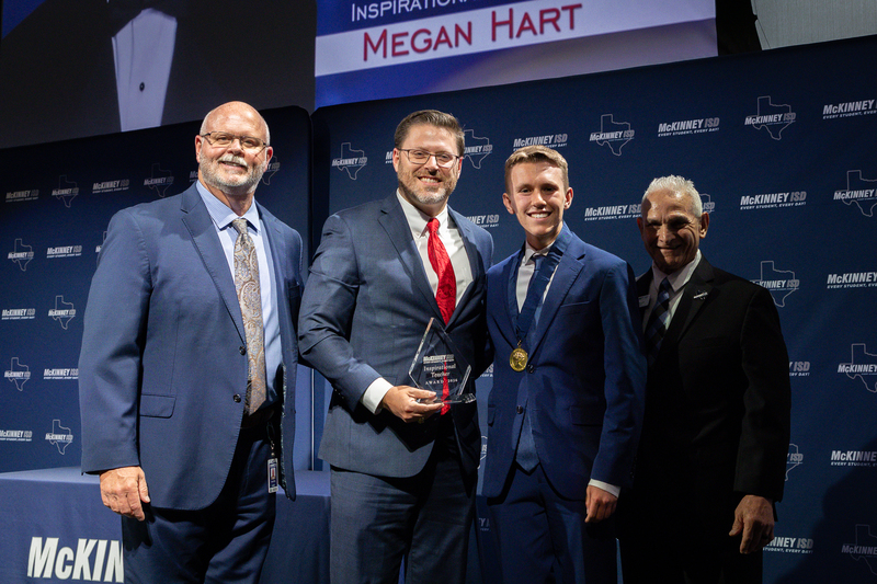 on stage with award