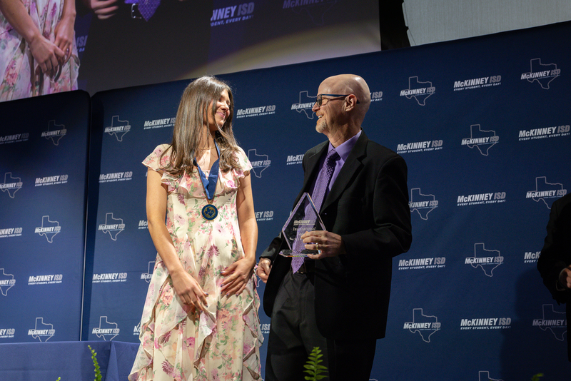 on stage with award