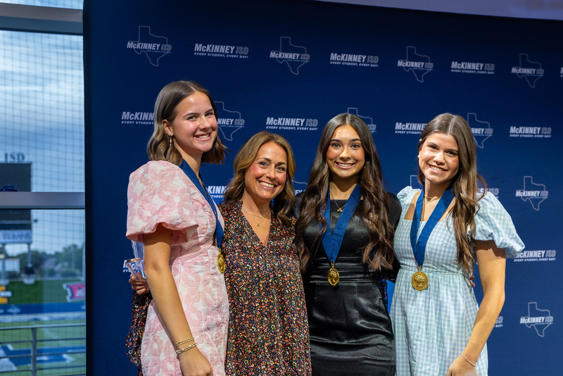 girls and teacher in group on stage