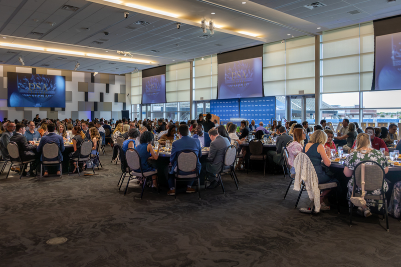 wide shot of everyone at tables