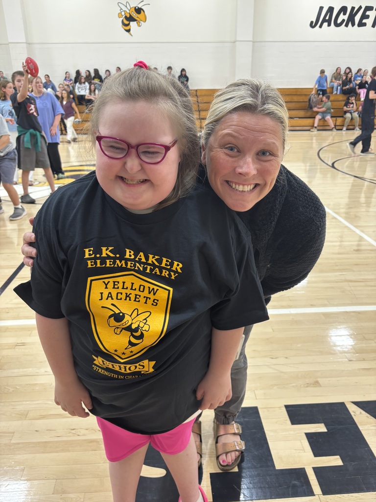 student and teacher smiling