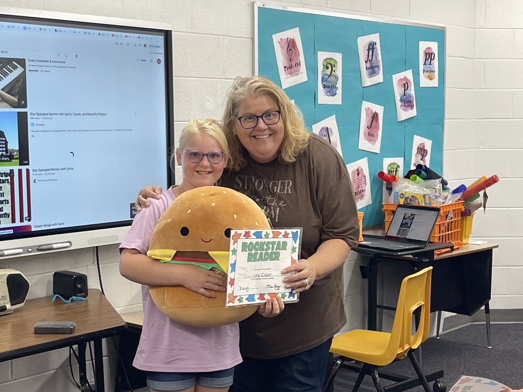 Lexi receiving her prize for reading over the summer.