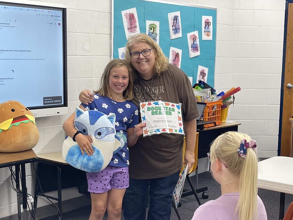 Reatta receiving her award for reading over 1,000 minutes this summer!
