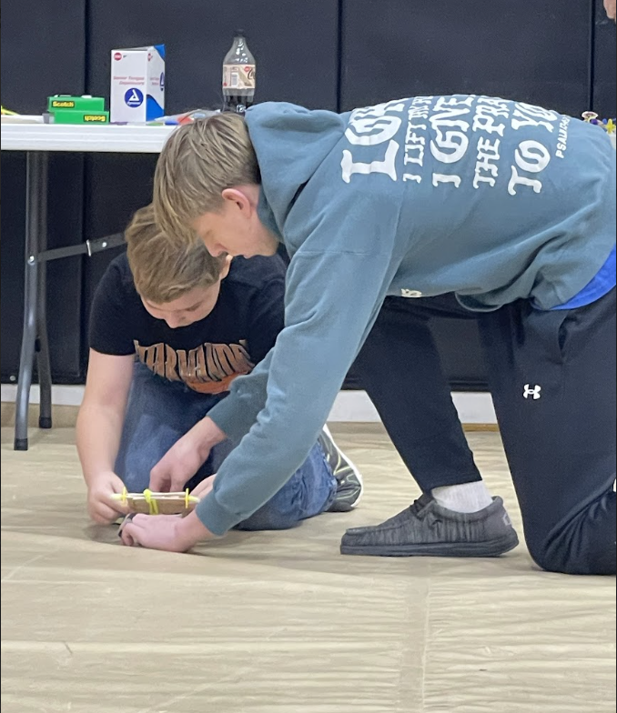 HAL Students working together to build a slingshot car. 