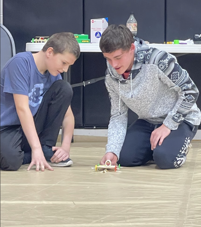 HAL Students working together to build a slingshot car. 