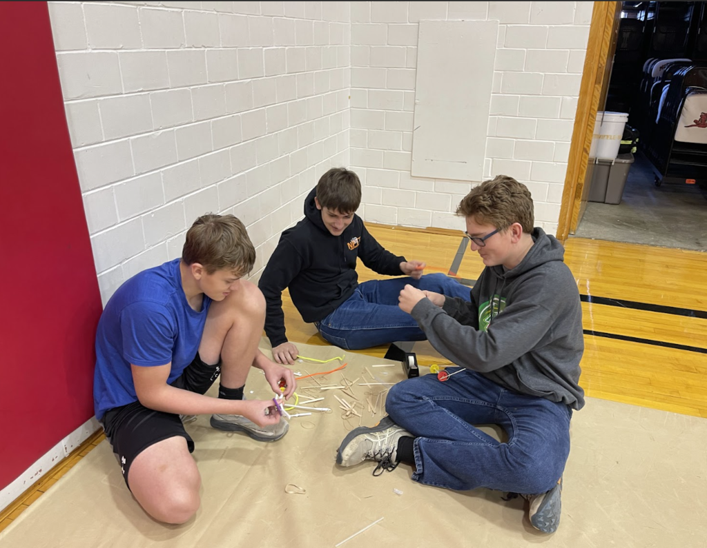HAL Students working together to build a slingshot car. 