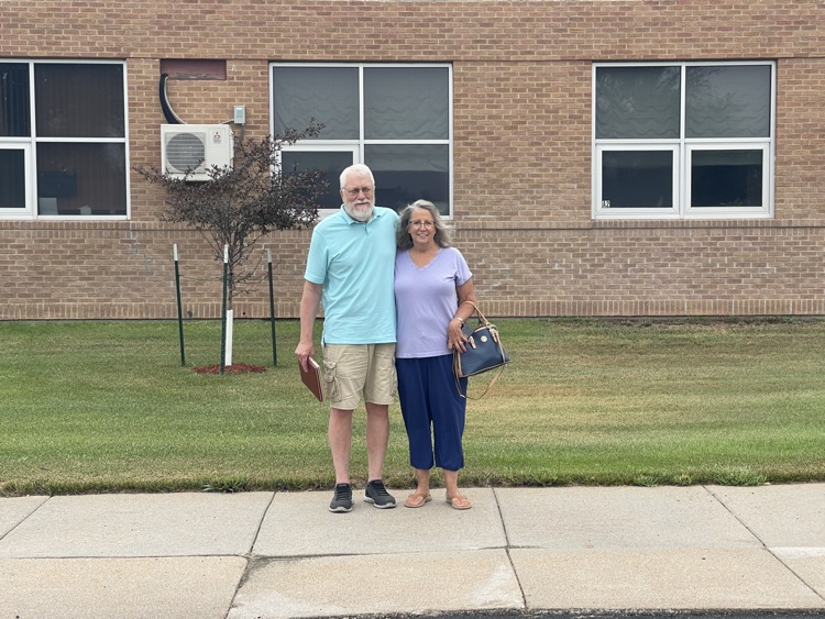 Douglas and Cheryl in front of the high school where his dad was superintendent.