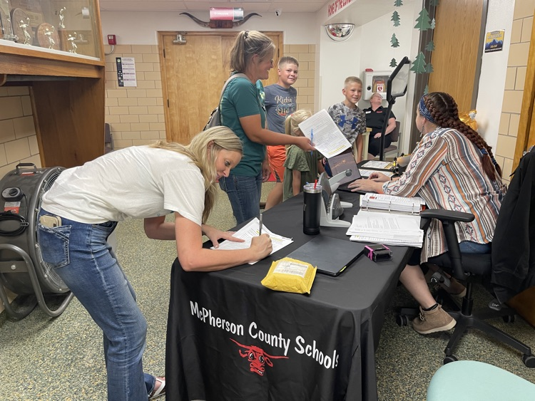 Families completing paperwork .