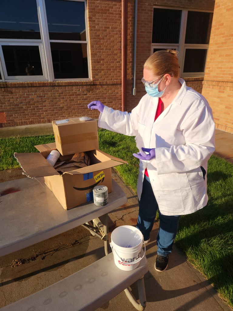 Mrs. Anderson demonstrating proper handling of chemicals.