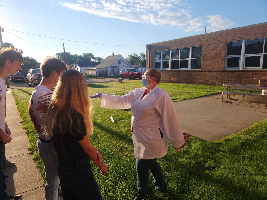 Mrs. Anderson demonstrating proper handling of chemicals.