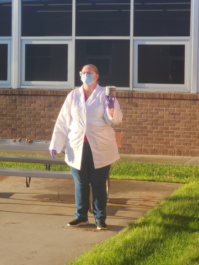 Mrs. Anderson demonstrating proper handling of chemicals.