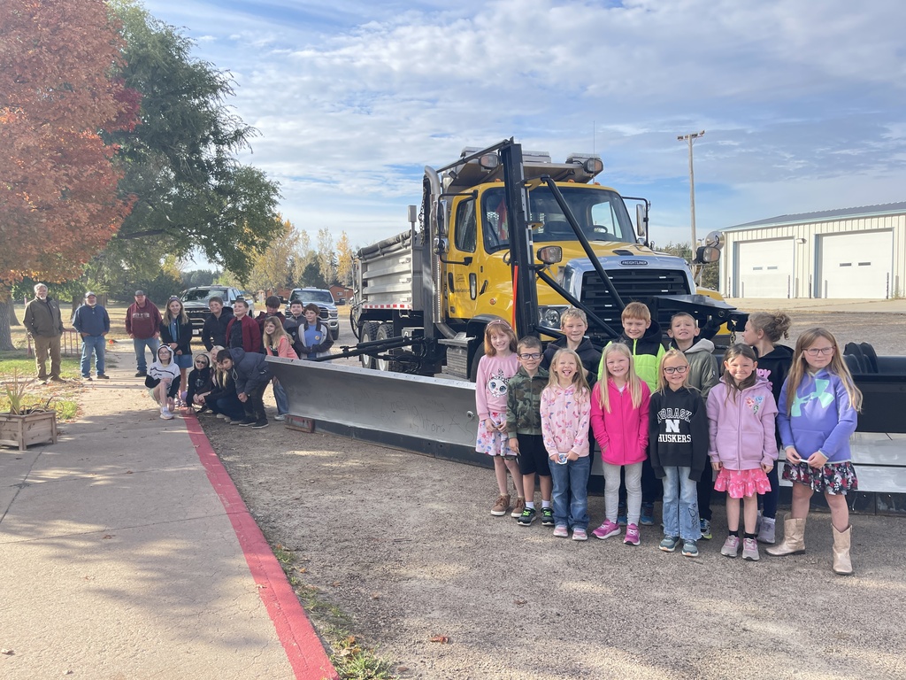 MCS elementary students around the newly named snow plow, Snowphie Cunningham. 