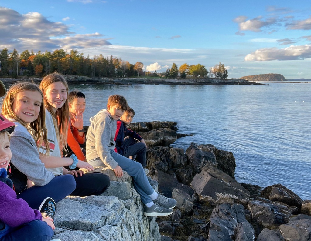kids on cliffs next to ocean