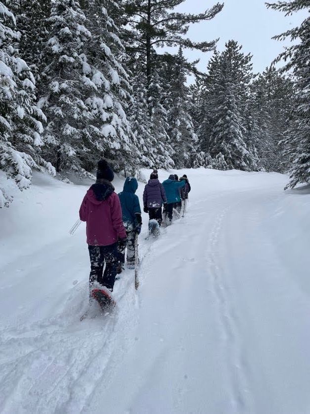 students snowshoeing