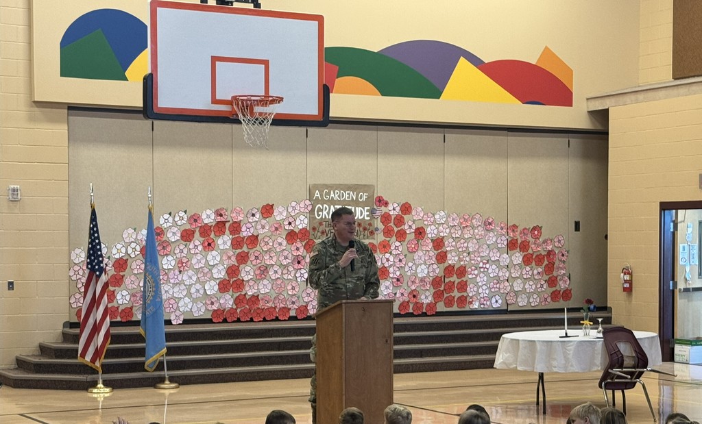 gym with flags and guest speaker