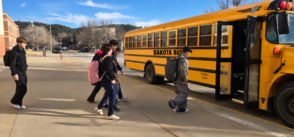 students walking to a bus