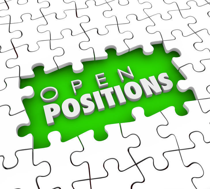 Open Positions (white) on a neon green background with white puzzel pieces around it.