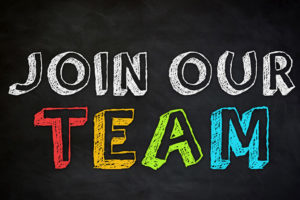 Join our Team written in chalk on a black chalk board.