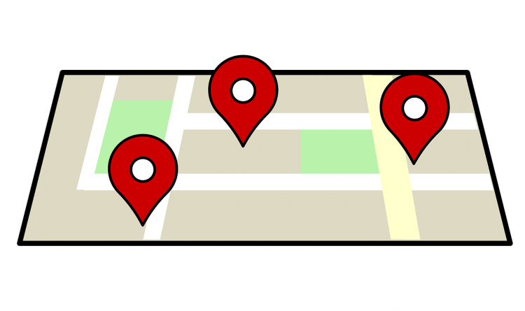 map that is outlined in black. The inside of the black is a cream area with white lines, and green fields. There is Red and white tear drop looking markers.