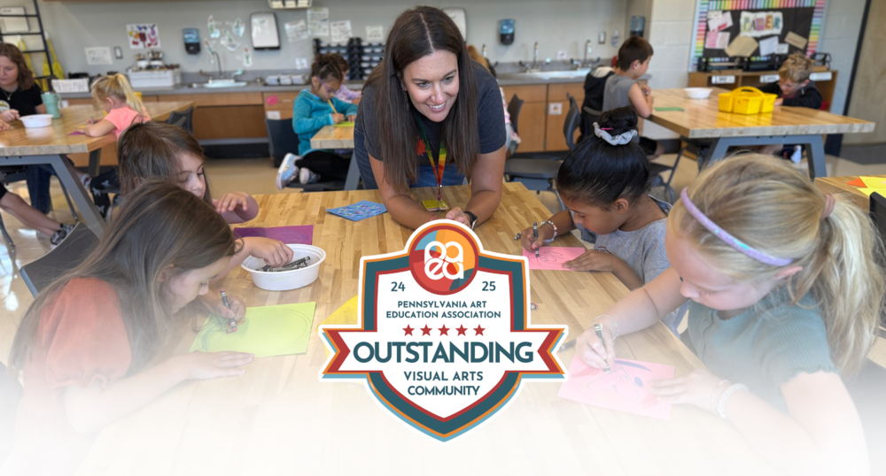 Students in an art class working at a desk while a teacher looks on. There's an Outstanding Visual Arts Community logo in the center.