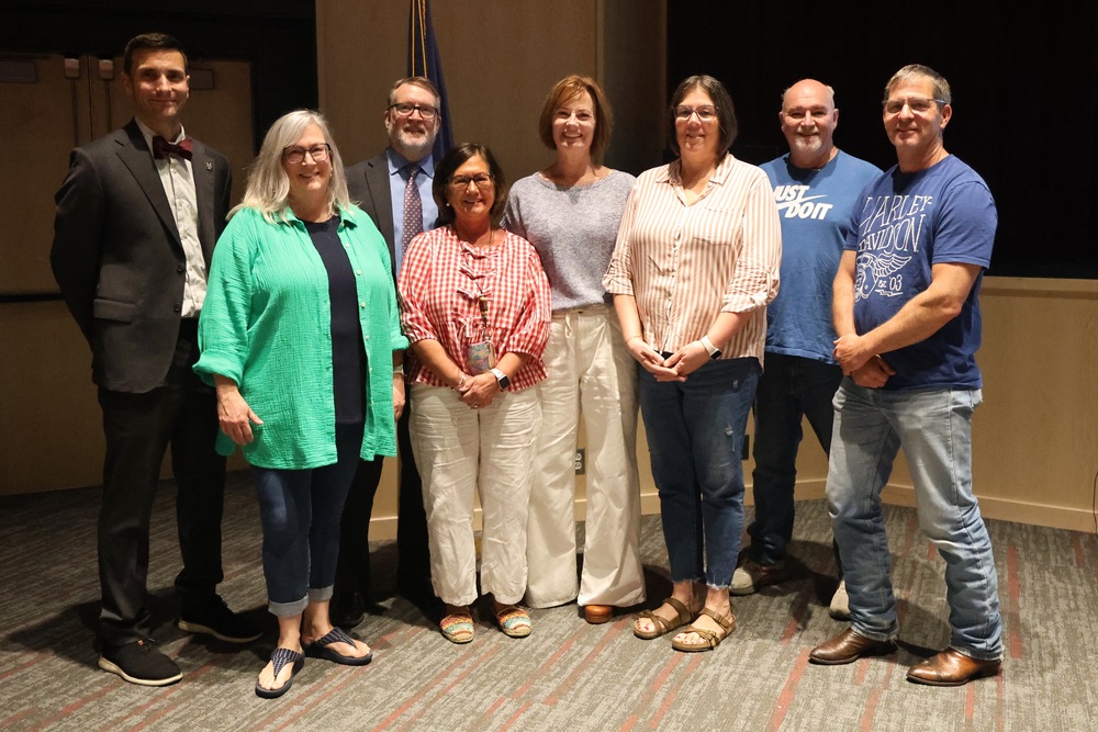 Group of retirees being recognized at a program.
