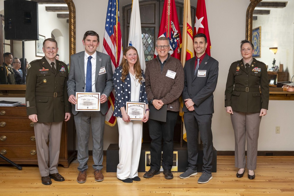 Military personnel presenting educators with a certificate of appreciation