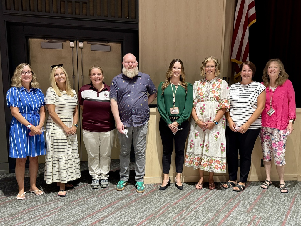 A group of adults standing in line for a recognition photo.
