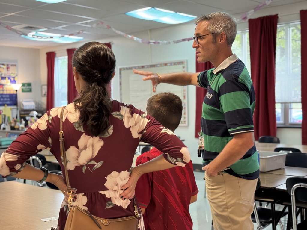 A teacher talking with a mom and son