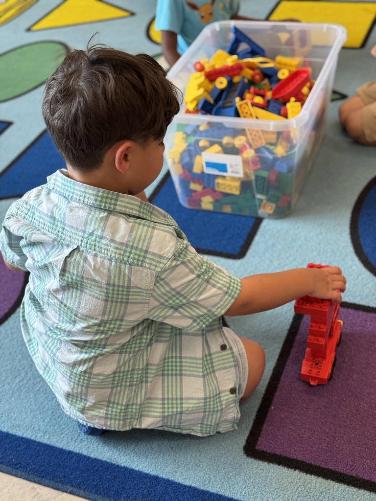 A young student builds with legos
