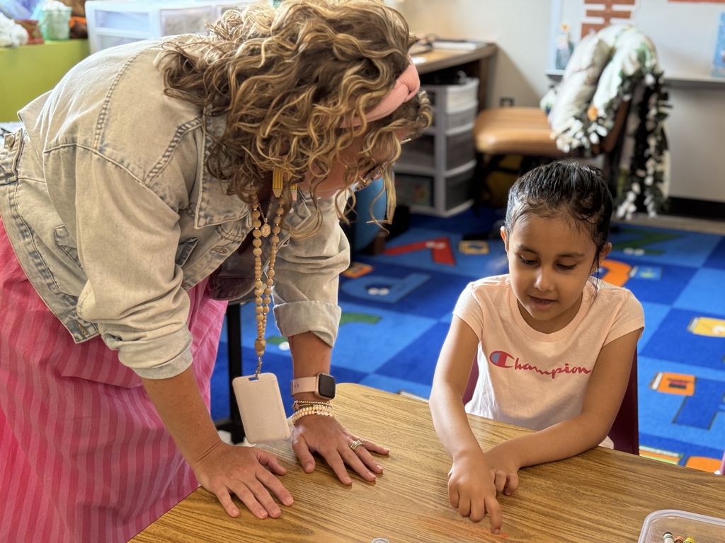 A young student works with a teacher